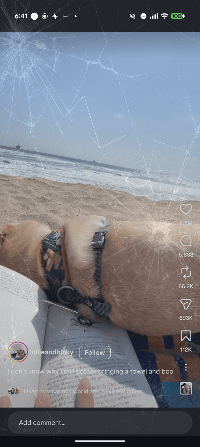 Cracked-screen overlay effect shattering across a beach video